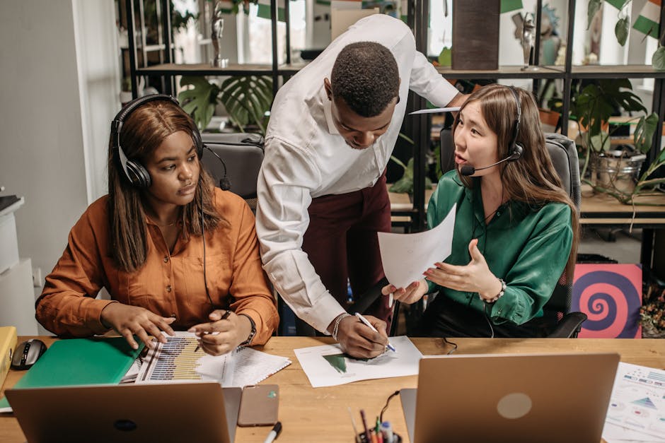 A diverse team of colleagues collaborating and smiling in a modern office space.